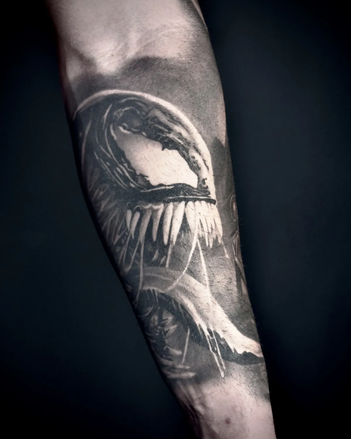 Fanged creature on the forearm, healed